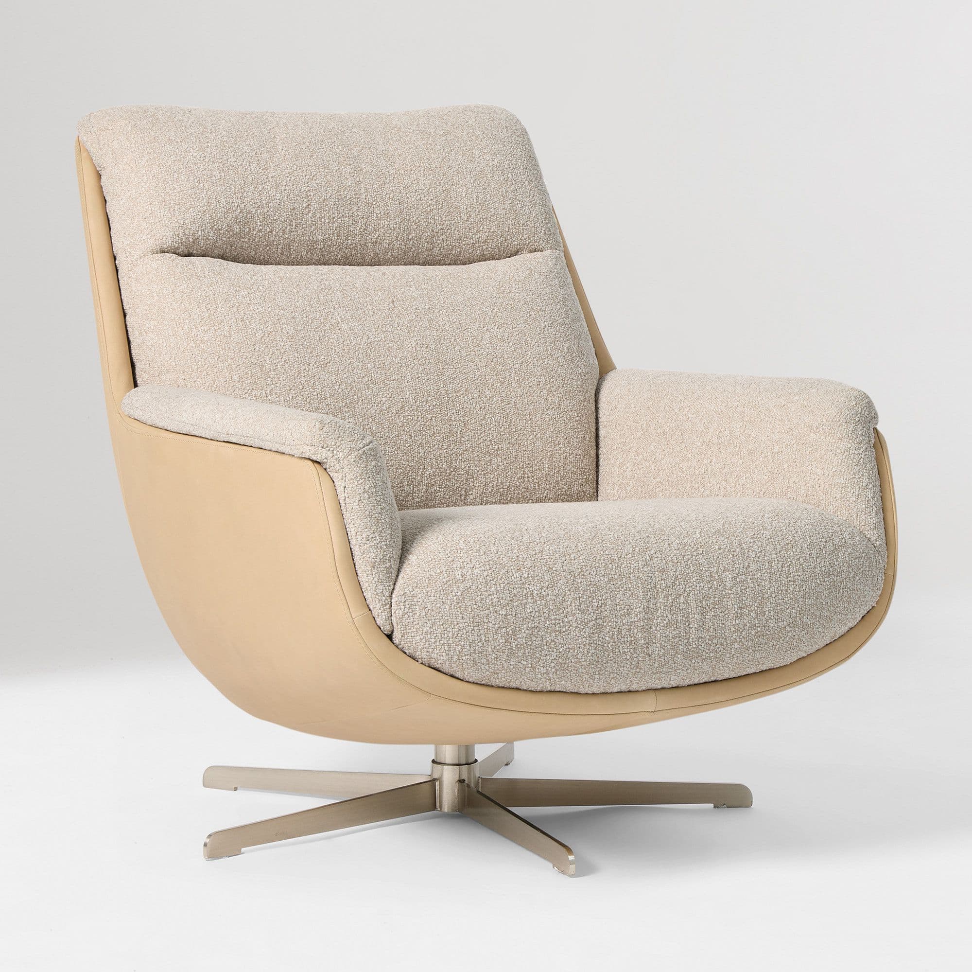 A contemporary armchair with a distinctive curved silhouette. The chair features a high backrest and integrated armrests. The seat and backrest are upholstered in a textured boucle fabric, while the outer shell appears to be made of smooth leather or a similar material. It is supported by a metal swivel base with four splayed legs. — 3D model