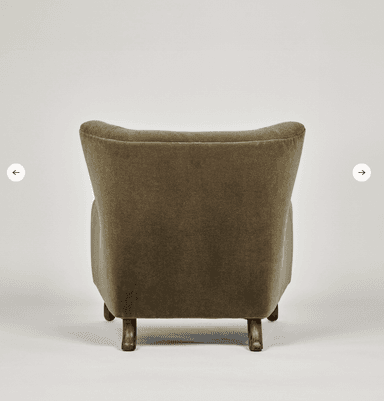 A high-backed upholstered lounge chair in a deep olive green velvet-like fabric, featuring button tufting on the backrest, rounded armrests, and short, splayed dark wood legs. — 3D model