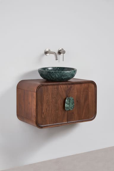 A contemporary wall-mounted bathroom vanity cabinet crafted from dark-stained walnut wood, featuring gracefully rounded edges. It is topped with a distinct dark green marble vessel sink and includes matching, organically shaped marble door pulls. A wall-mounted brushed metal faucet set completes the unit. — 3D model