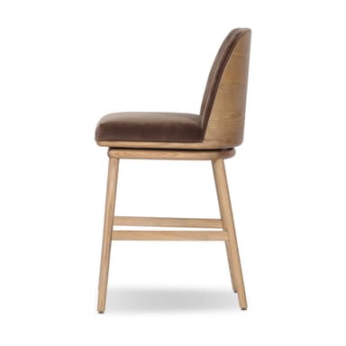 A bar stool with a wooden base and a upholstered seat and backrest. The stool has a swivel mechanism. The wooden legs are angled outwards, and there are crossbars for stability. The seat and backrest are covered in a textured fabric, likely velvet, in a brown hue. — 3D model
