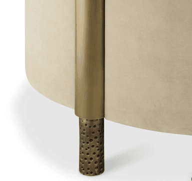 A contemporary armchair with a boxy silhouette and a plush velvet upholstery in a neutral beige tone. The armchair features a high back and armrests that are integrated into the main body, creating a continuous form. The front legs are block-shaped and upholstered, while the rear legs appear to be a decorative, metallic material with an irregular texture. — 3D model
