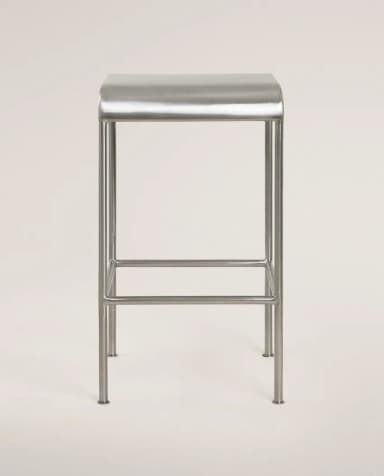 A minimalist, contemporary bar stool constructed from brushed metal, featuring a rectangular seat with subtly rounded edges and a four-legged base with an integrated footrest. — 3D model