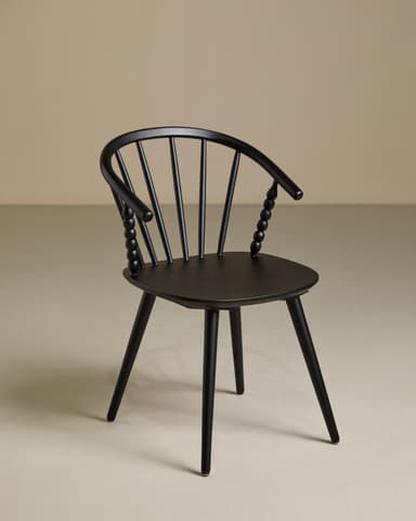 A contemporary armchair featuring an all-black finish. It has a curved spindle backrest that flows into integrated armrests. Distinctive spherical turned details adorn the ends of the armrests where they meet the seat. The seat is a flat, subtly contoured disc, supported by four splayed and tapered legs. — 3D model