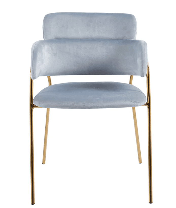 A contemporary armchair featuring a plush velvet upholstery in a soft blue hue. The chair is designed with a low, integrated armrest and a supportive backrest, both padded for comfort. Its frame consists of slender, polished gold-toned metal legs that extend from beneath the seat and support the structure. The overall aesthetic is modern and elegant, with a focus on tactile materials and a minimalist silhouette. — 3D model