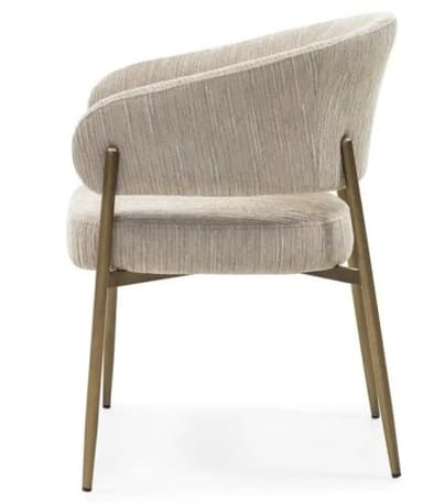 A contemporary armchair with a gently curved backrest and integrated armrests. The seat and back are upholstered in a textured, neutral-toned fabric. It is supported by slender, metallic legs with a brass or bronze finish. — 3D model