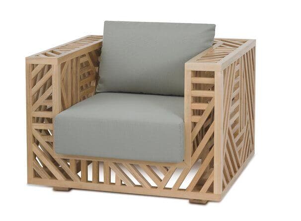 A modern armchair featuring a boxy, open-work frame crafted from light-toned wood with an intricate geometric slatted pattern. The chair includes a plush light gray fabric seat cushion and a matching back cushion, providing a comfortable seating surface within its architectural structure. The design emphasizes clean lines and a contemporary aesthetic. — 3D model