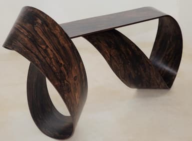 A sculptural console table with a continuous, ribbon-like form, crafted from a dark, heavily-grained wood veneer. — 3D model