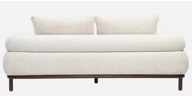 A side view of a contemporary sofa featuring thick, rounded, cream-colored boucle upholstery and a minimalist dark wood base with cylindrical legs. — 3D model