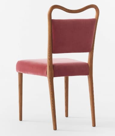A contemporary dining chair featuring a gracefully curved wooden frame and plush velvet upholstery. The chair has a medium-toned wooden structure with a subtly curved backrest that flows into the rear legs, and straight tapered front legs. Both the seat and the backrest are upholstered in a rich, reddish-pink velvet fabric. — 3D model