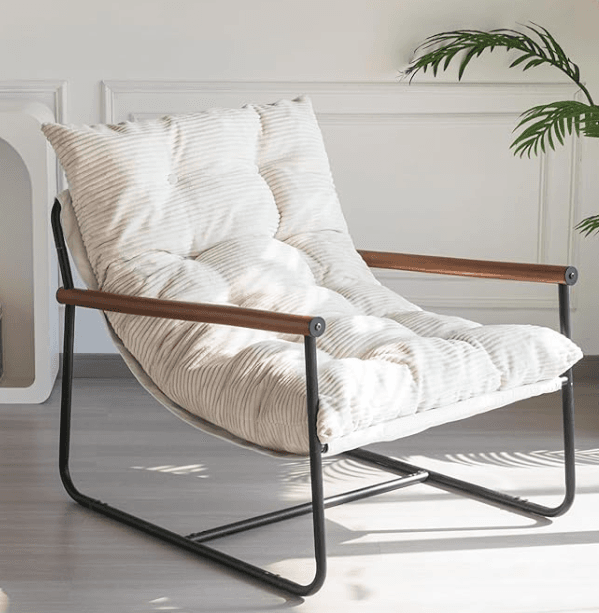 A contemporary lounge chair featuring a minimalist black metal frame, wooden armrest sleeves, and a generously padded, button-tufted off-white corduroy cushion. The design emphasizes comfort and a relaxed posture, blending industrial elements with soft, inviting upholstery. — 3D model