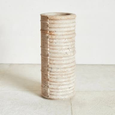 A large, cylindrical decorative vase featuring a distinctive two-tone, two-texture design. One half of the exterior is characterized by prominent, deeply grooved horizontal ribbing with a visibly distressed, aged finish, while the other half presents finer, more regular horizontal ridges with a lighter, slightly smoother appearance. The overall form is tall and narrow, suggesting use as a floor vase or large planter. — 3D model