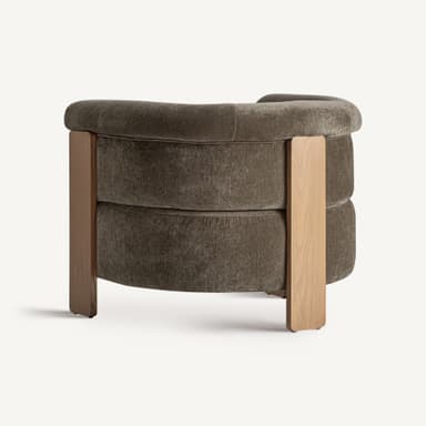 A single-seater armchair with a plush, upholstered body and a distinctive wooden frame. The upholstery features a textured, boucle-like fabric in a muted brown or taupe color. The frame consists of vertical wooden elements that extend from the base to support the arms and back. The seat and back cushions appear integrated into the overall form, creating a rounded, inviting silhouette. The wooden legs are thick and angular, contributing to a modern yet substantial aesthetic. The stitching on the upholstery is visible and appears to be of high quality. — 3D model
