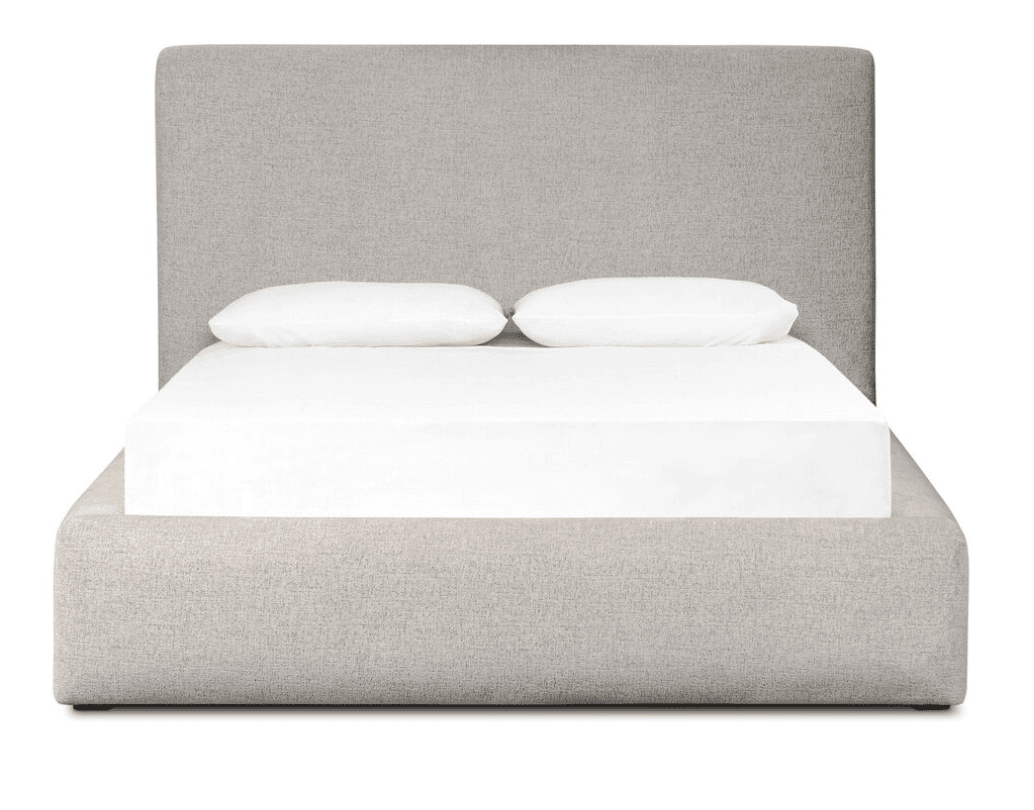 A modern platform bed, fully upholstered in a light grey or oatmeal-colored textured fabric. It features a streamlined, low-profile design with a built-in rectangular headboard and rounded edges on the frame. The bed frame encloses a mattress, which is visible with white sheets and two white pillows. — 3D model