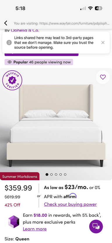 A contemporary platform bed featuring a light beige fabric upholstery on both the headboard and the frame, supported by dark, tapered legs. — 3D model