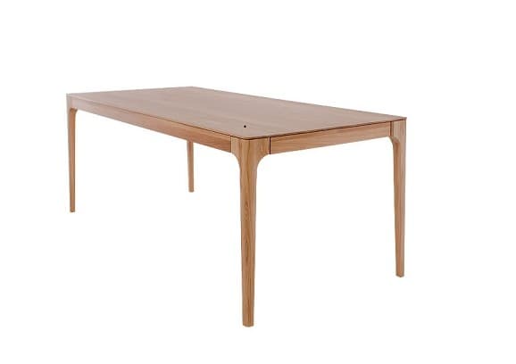 A modern rectangular dining table crafted from light-toned solid wood, likely oak or beech. It features a clean, unadorned tabletop and four gracefully tapered legs. The legs have a subtle outward curve at their junction with the table apron, creating a refined and integrated appearance. — 3D model