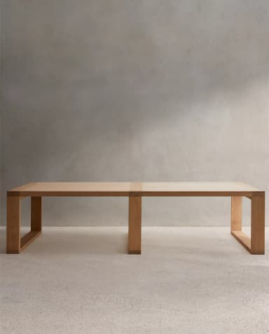 A long, low contemporary wooden bench crafted from light-toned wood, featuring a minimalist design with open rectangular frame legs at each end and a solid central support structure. The top surface is flat and elongated, suitable for seating or as a low console. — 3D model