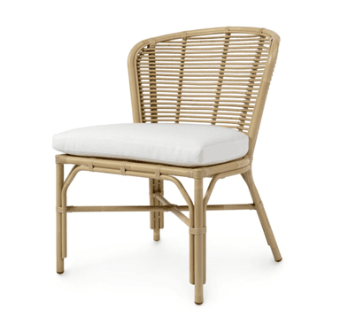 A natural rattan dining chair featuring a curved, woven backrest and a solid frame construction. The seat is fitted with a removable white upholstered cushion. The chair's frame utilizes bent rattan poles, with smaller rattan strands woven to form the backrest, showcasing traditional craftsmanship. The design is lightweight and suitable for various casual or tropical-inspired settings. — 3D model