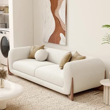 A contemporary two-seater sofa featuring a clean, rounded silhouette and a distinctive integrated wooden base. The sofa is upholstered in a textured, cream-colored fabric, likely bouclé or a similar woven material. It includes two back cushions and three accent pillows—two square and one round—in a complementary light brown hue. The dark wooden base wraps around the lower part of the sofa, providing both structure and a stylish visual contrast to the light upholstery. The design emphasizes comfort with its soft edges and plush appearance. — 3D model