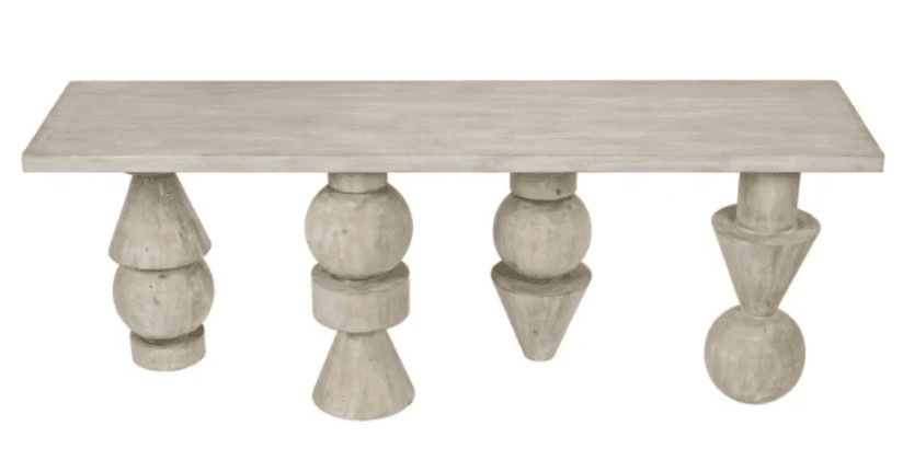 An elongated, rectangular coffee table crafted from wood with a light, whitewashed finish. It features four distinct, sculptural legs, each composed of uniquely stacked geometric shapes such as spheres, cones, and cylinders, providing a dynamic and artistic base. — 3D model
