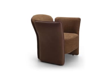 A contemporary upholstered armchair featuring a rounded backrest and integrated armrests that flow down to form the base. The chair is predominantly covered in a textured brown fabric, likely a tweed or boucle. The outer panels of the armrests, from the top down to the floor, are finished in a smoother, slightly darker brown material, possibly faux leather or a contrasting plain fabric, creating a subtle two-tone effect. The design emphasizes comfort with its soft curves and plush appearance, without visible legs. — 3D model