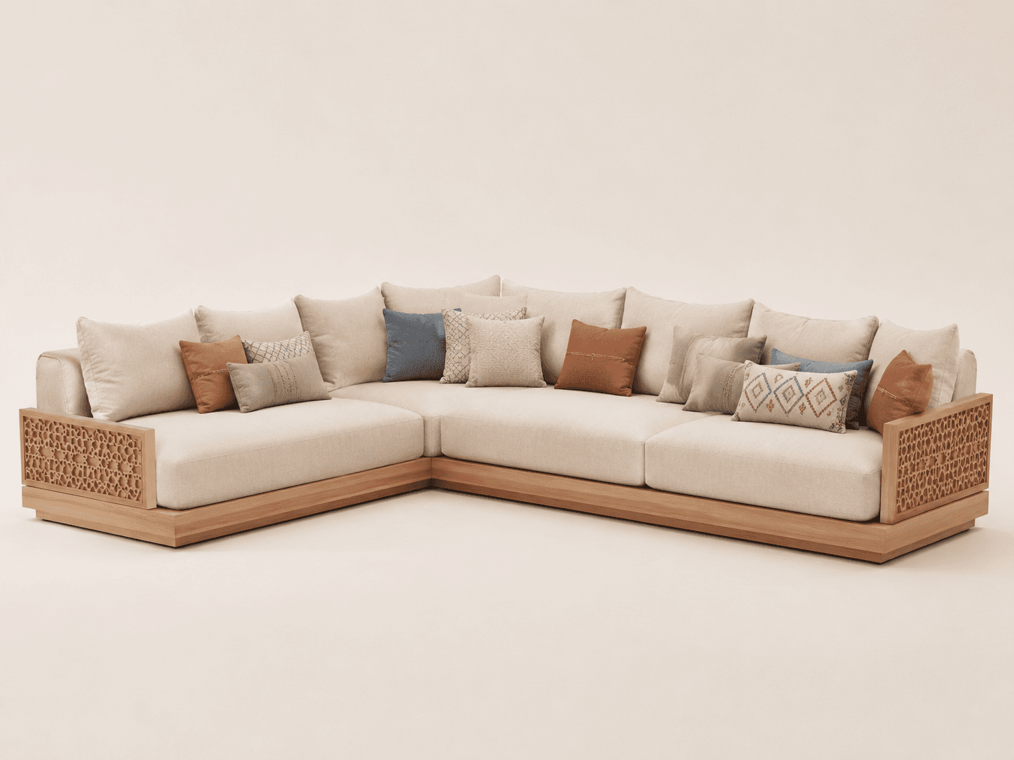 An L-shaped sectional sofa featuring a low-profile natural wood base, intricately woven rattan armrest panels, and plush light-beige fabric cushions, accompanied by an assortment of decorative accent pillows. — 3D model