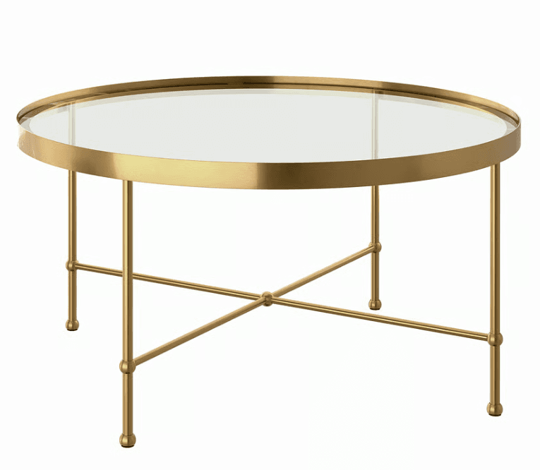A round coffee table featuring a clear glass top and a polished brass-finished metal frame and legs, designed with an X-shaped stretcher for stability. — 3D model