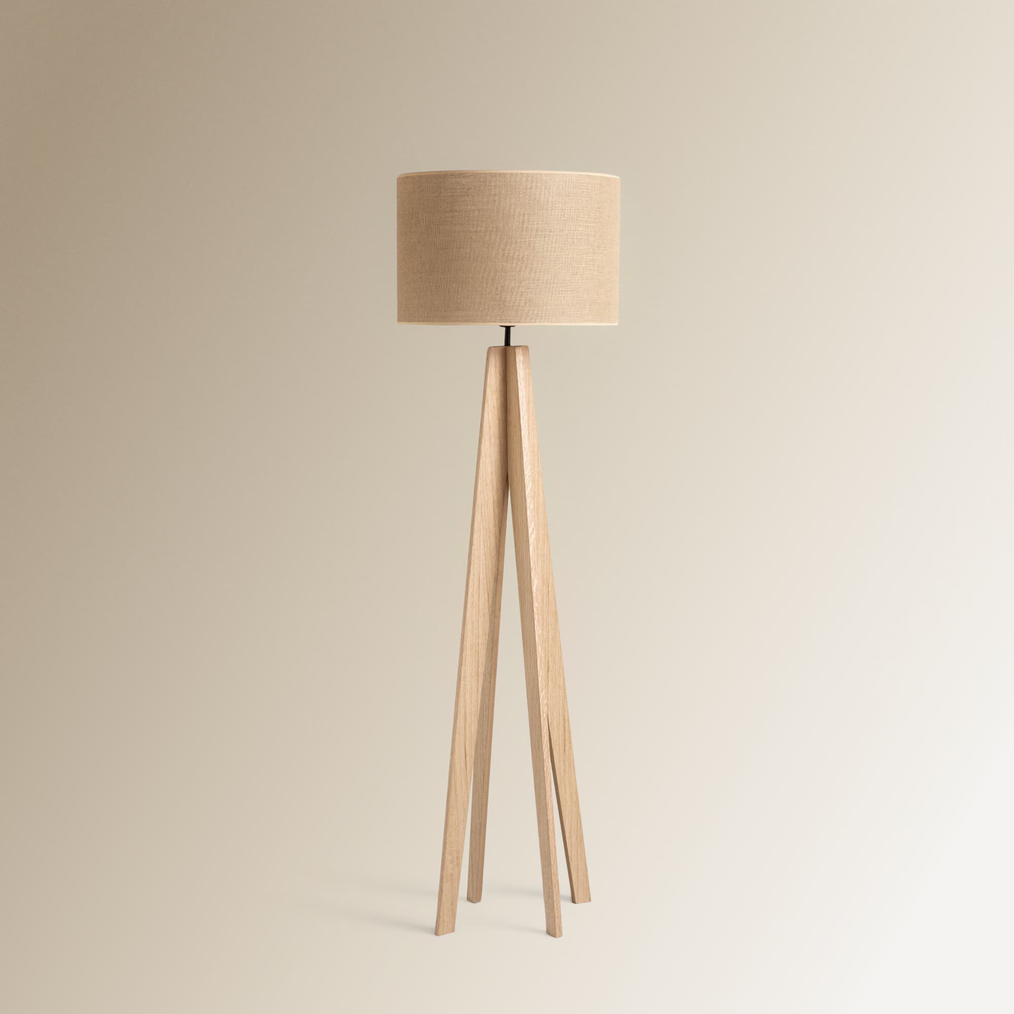 A modern floor lamp featuring a cylindrical, light-colored linen fabric shade atop a splayed, light-toned wooden tripod base. The design is minimalist, emphasizing natural materials and clean lines. — 3D model