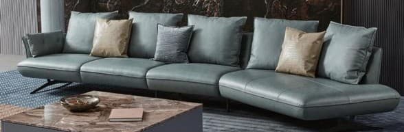 A contemporary U-shaped sectional sofa upholstered in a light teal or dusty blue fabric, featuring a low-profile design and slender black metal legs. The sofa consists of multiple modular components, including corner and armless sections, allowing for a versatile configuration. It comes with numerous back cushions and a selection of accent pillows in varying shades of beige and gray, adding texture and visual interest. The design emphasizes comfort and modern minimalism. — 3D model