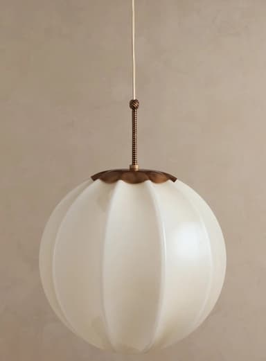 A single pendant light featuring a spherical, fluted opal glass shade suspended from a white cord with brass-toned metal fittings. — 3D model