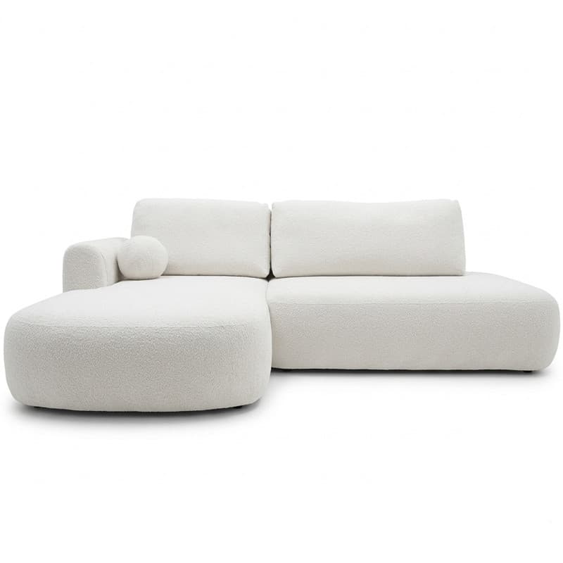 An L-shaped sectional sofa upholstered in white or off-white boucle fabric, featuring soft, rounded edges and a low-profile design. The sofa consists of two main modules: a two-seater section and a right-hand chaise lounge. It includes two back cushions, one integrated cylindrical armrest on the chaise side, and a matching spherical accent pillow. — 3D model