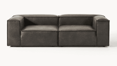 A dark grey modular sectional sofa, upholstered in distressed faux leather, featuring a low profile and rounded, plush cushions, seen from the rear and side. — 3D model