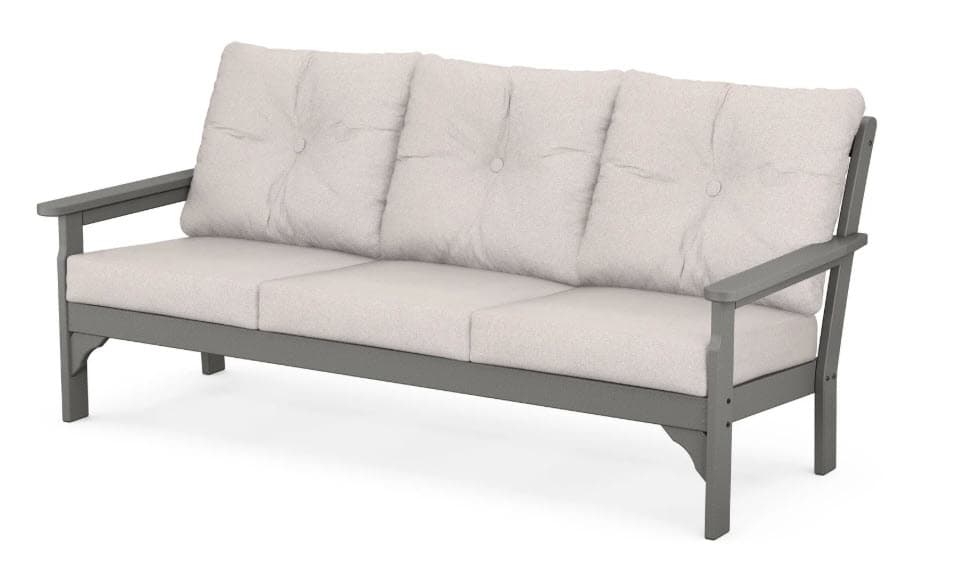 A three-seater sofa with a grey, angular frame and light beige cushioned seating and backrest. The backrest is composed of three separate tufted cushions, each secured with a single button. The armrests are straight and extend from the frame. The sofa has a clean, modern aesthetic, likely intended for outdoor use. — 3D model