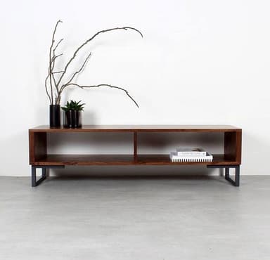A long, low-profile media console featuring a dark brown wood-look finish and two open storage compartments. It is supported by black, U-shaped metal legs at each end, contributing to its modern industrial aesthetic. The design is simple, functional, and features clean lines. — 3D model