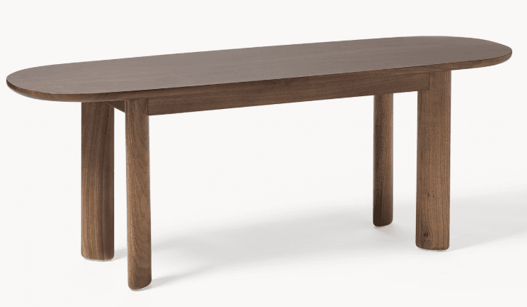 A low-profile bench featuring an elongated oval top crafted from dark solid wood, supported by four sturdy, cylindrical wooden legs with a slightly flattened profile. — 3D model