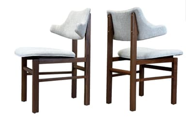 A contemporary dining chair featuring a dark wood frame and light gray fabric upholstery. The chair has a distinctive sculpted backrest with a slight curve, providing an ergonomic and stylish profile. The four-legged frame is constructed from solid wood, suggesting durability and stability. — 3D model