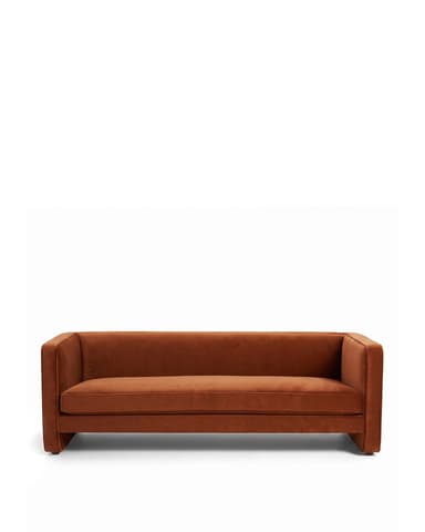 A contemporary three-seater sofa with a sleek, minimalist design. It features a low-profile frame with integrated arms that extend to the front, creating a cohesive look. The upholstery appears to be a soft, plush fabric with a matte finish, and the seat and back cushions are well-defined. The sofa sits on block-style legs integrated into the frame. — 3D model