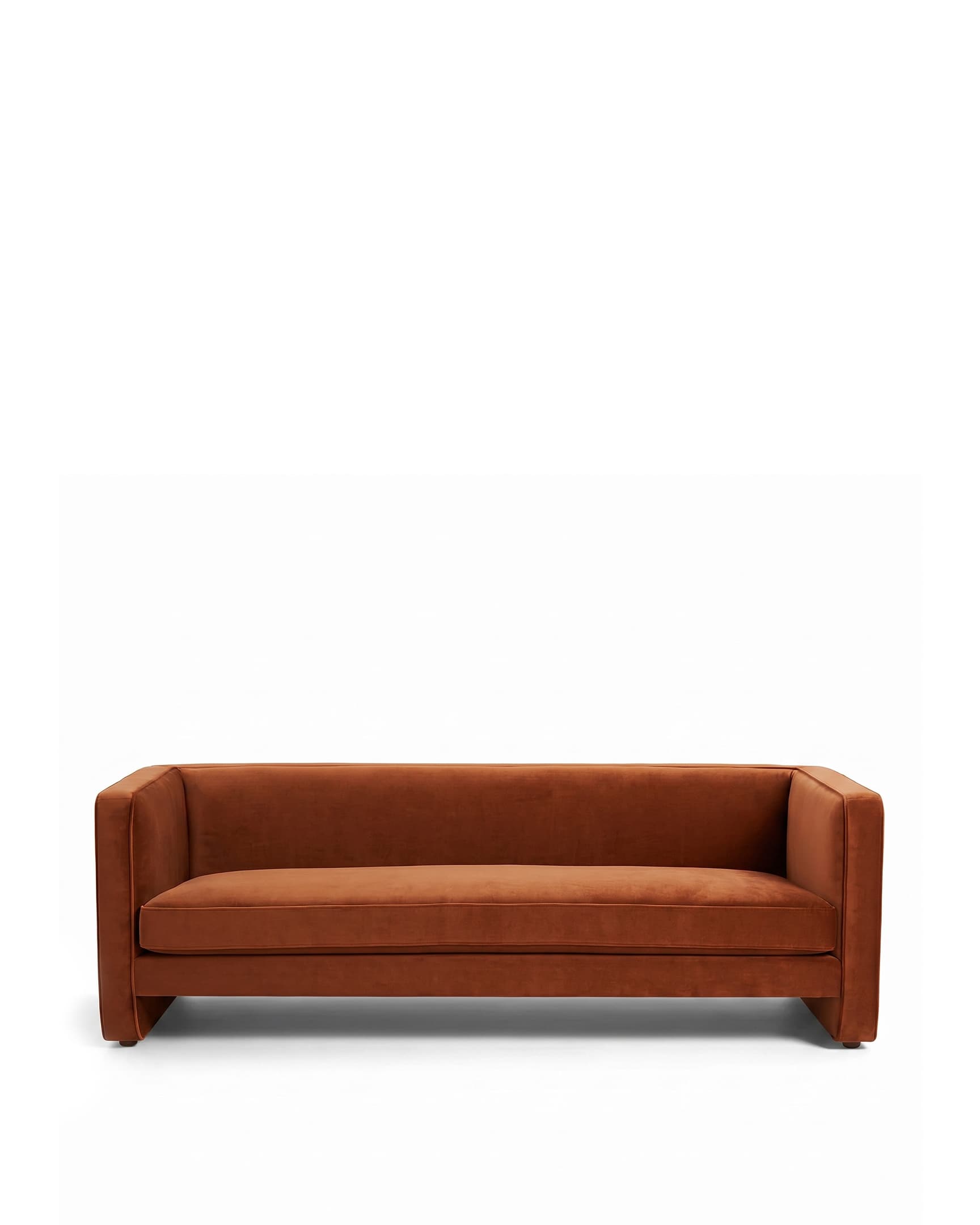 A contemporary three-seater sofa with a sleek, minimalist design. It features a low-profile frame with integrated arms that extend to the front, creating a cohesive look. The upholstery appears to be a soft, plush fabric with a matte finish, and the seat and back cushions are well-defined. The sofa sits on block-style legs integrated into the frame. — 3D model