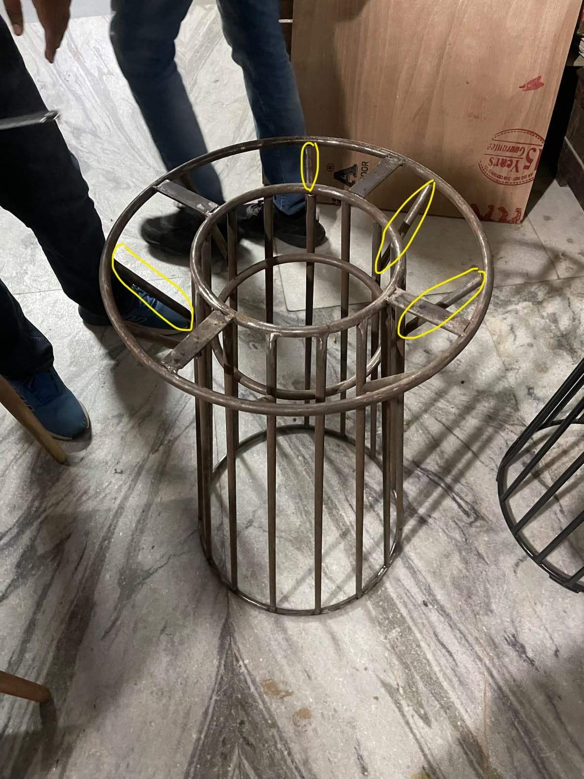 A cylindrical, open-cage metal structure designed to serve as a base, likely for a small table or a plant stand. It features a dark finish and an industrial aesthetic. — 3D model