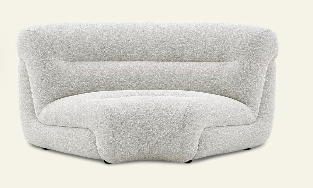 An armless lounge chair upholstered in a light-colored bouclé fabric, featuring a soft, rounded, and sculptural form. The chair has a low-profile design with a continuous backrest that includes a subtle horizontal channel detail. Its base is minimal with small, dark, recessed feet, contributing to a modern, plush aesthetic. — 3D model