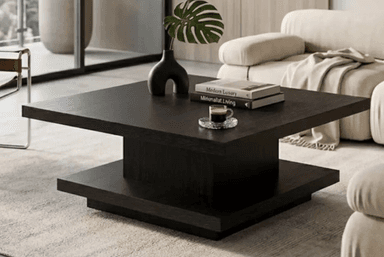 A minimalist square coffee table featuring a two-tiered design in a dark wood finish. The table consists of a flat, square top surface elevated above a matching square base by a shorter, central square block, creating a floating appearance. The material appears to be engineered wood with a dark wood grain laminate or veneer, exhibiting clean lines and a contemporary aesthetic. — 3D model