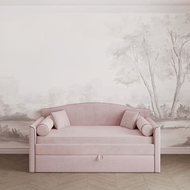 A pink upholstered daybed featuring a gently curved backrest and armrests, adorned with a houndstooth pattern on its side panels and lower front. It includes bolster pillows and square accent pillows, and has a pull-out mechanism underneath for storage or a trundle bed. — 3D model