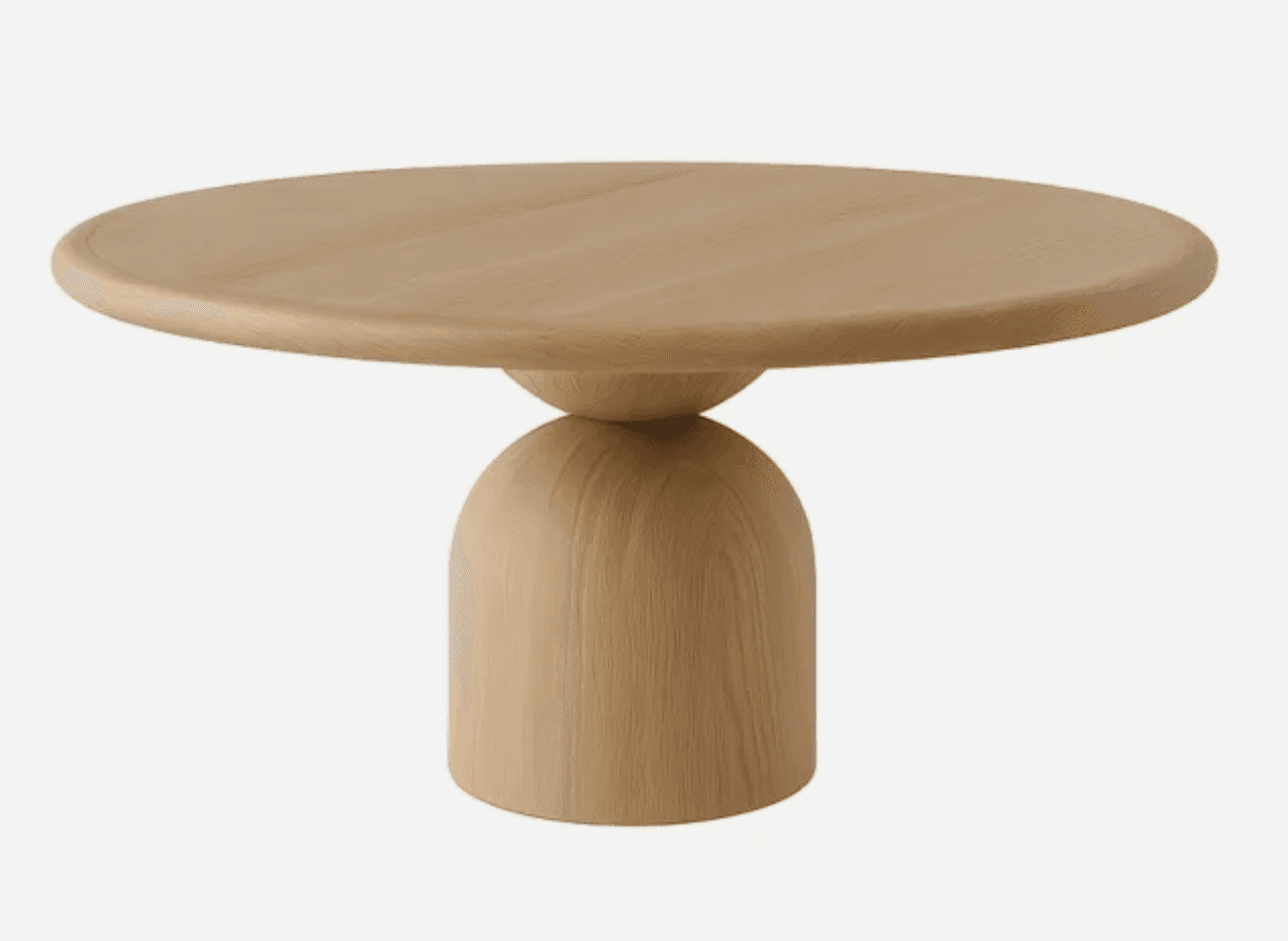 A modern coffee table with a round, flat top supported by a unique, sculptural pedestal base. The base consists of two parts: a lower, wider, rounded rectangular section and an upper, spherical element connecting the base to the tabletop. The grain of the wood is visible, indicating a natural material. — 3D model