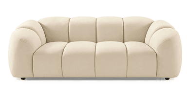 A contemporary sofa with a plush, channel-tufted design. The sofa features rounded, organic shapes with vertically segmented cushioning on the back and seat. It has integrated armrests that flow seamlessly into the backrest and a low profile. The piece is upholstered in a soft-touch fabric and rests on small, dark-colored legs. — 3D model
