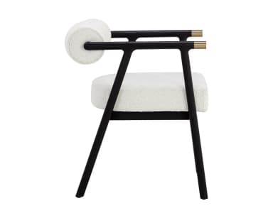 A contemporary armchair featuring a dark, possibly black-stained, wooden frame with clean lines. The seat and cylindrical backrest are upholstered in a light, textured fabric, resembling bouclé or a similar weave. The armrests are an extension of the frame, culminating in subtle brass-finished accents on the outer edges. The chair's design combines minimalist aesthetics with comfortable padding, suitable for various modern interiors. — 3D model