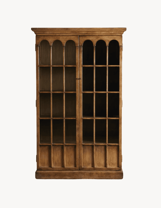 A tall, two-door wooden bookcase with glass panes. The doors are divided into multiple rectangular sections by wooden mullions. The top of the bookcase features an arched molding. The interior appears to have several shelves, also divided by mullions. — 3D model