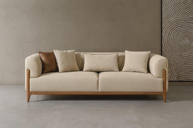 A modern three-seater sofa featuring a light beige fabric upholstery and a distinctive exposed wood frame. The sofa has rounded armrests, two large seat cushions, and three loose back cushions, along with two accent pillows, one of which is brown. — 3D model