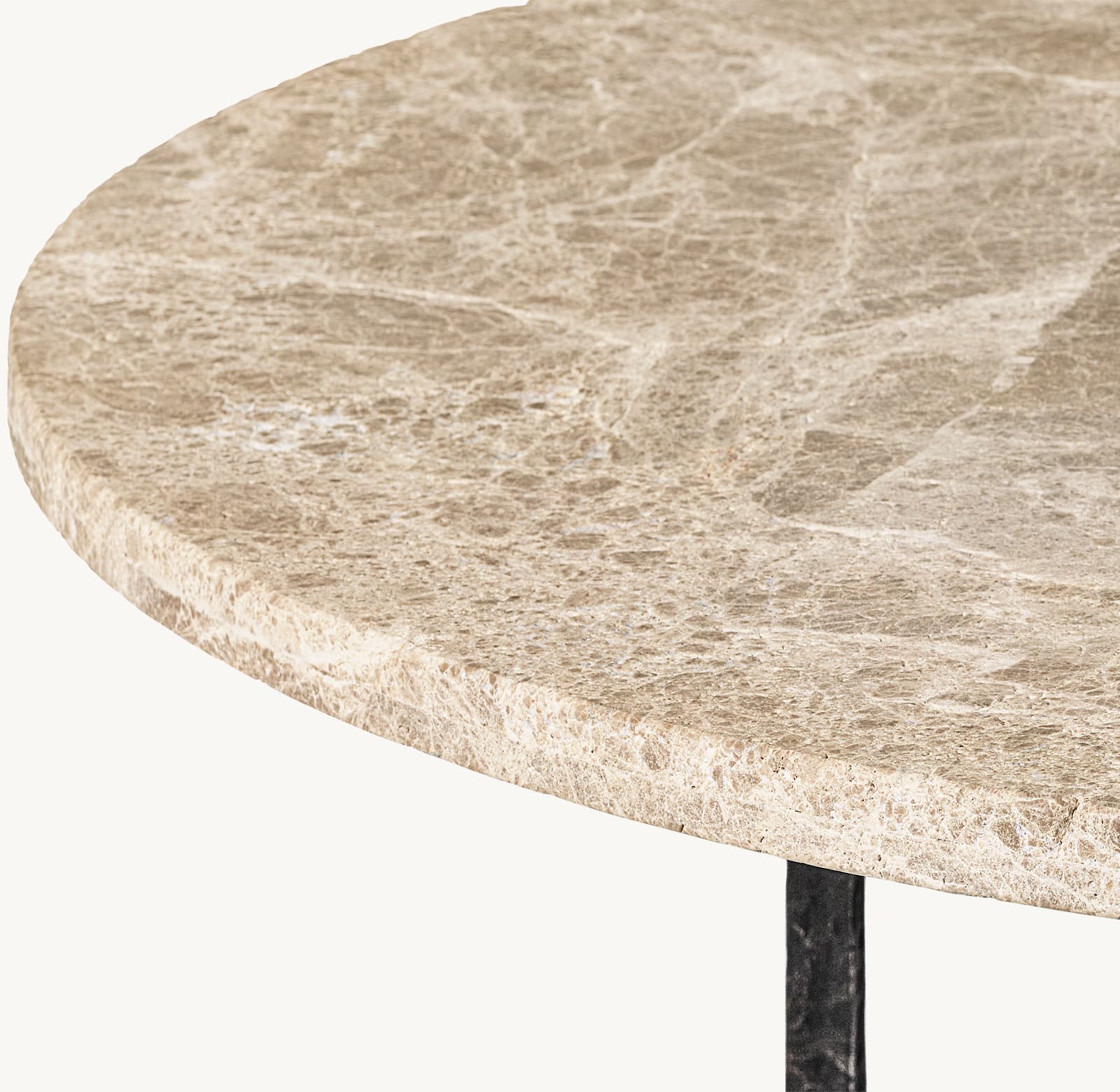 A close-up view of a round tabletop made of natural stone with a prominent veined pattern. The edge of the tabletop is visible, showing its thickness and textured surface. A dark-colored, likely metal, support structure is partially visible beneath the tabletop. — 3D model