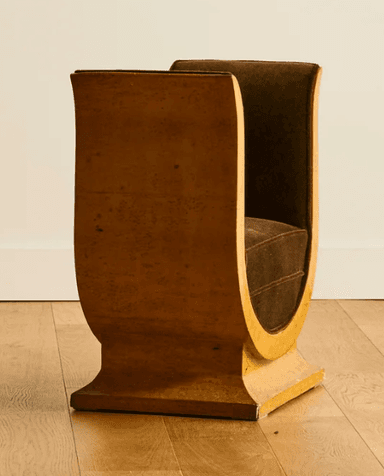 A distinctive bench with a U-shaped frame supporting a cushioned seat. The frame has a glossy, textured finish and appears to be made of wood or a composite material. The seat is upholstered in a dark brown velvet fabric. The overall design suggests a modern or art deco influence. — 3D model