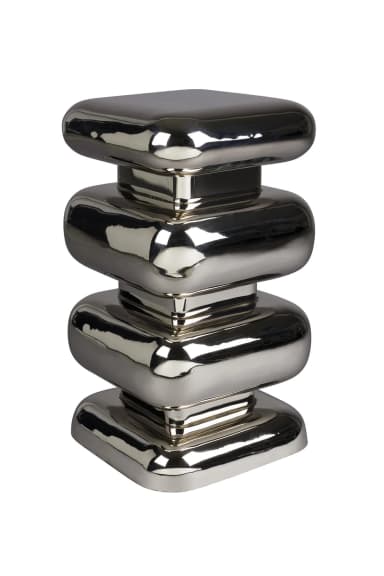 A side table with a stacked, abstract design. The structure consists of four rounded, square-like blocks stacked vertically. Each block is slightly indented from the one below it, creating a tiered effect. The overall form is smooth and highly reflective, with a polished chrome finish. — 3D model