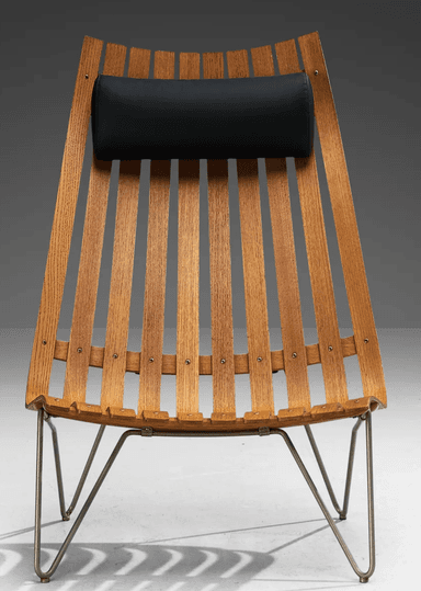 A mid-century modern lounge chair featuring a distinctive slatted wooden back and seat, supported by a minimalist metal wire frame. The chair includes a cylindrical black leather or vinyl headrest for comfort. Its design emphasizes ergonomic curves and a lightweight aesthetic. — 3D model
